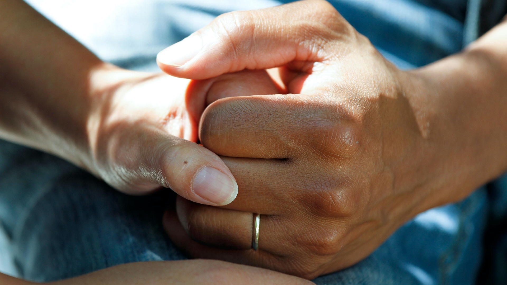 Close up of people holding hands