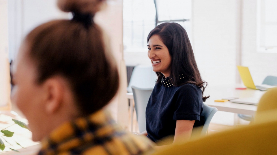 Woman sat in office smiling