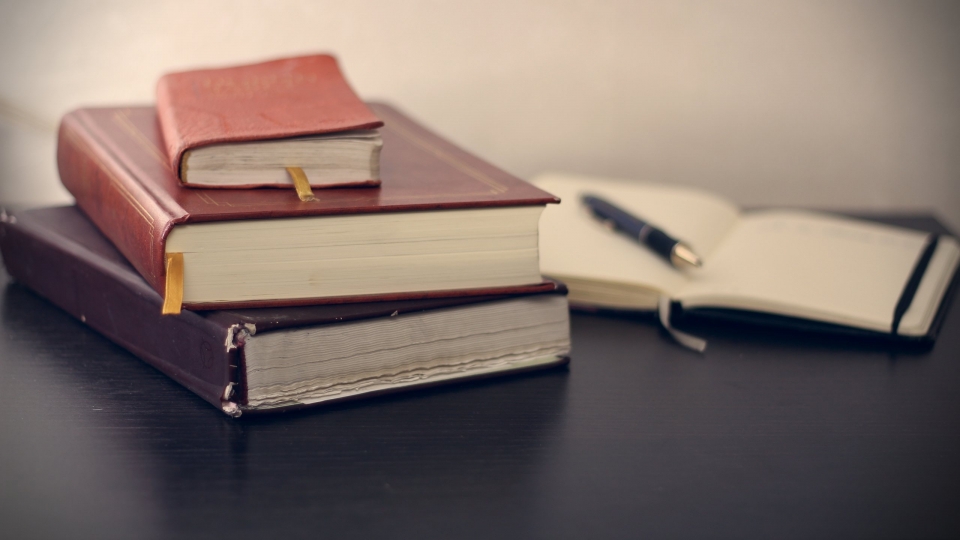 Books and a pen on a table